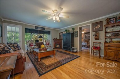 Living room with hardwood floors.  Bedroom #1 seen