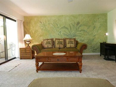Living room has a feature wall with a green plaste