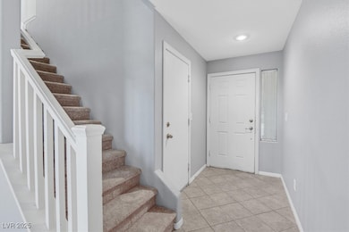 Entryway featuring light tile patterned floors and