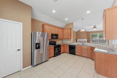 This bright and spacious eat-in kitchen features modern  appliances, ample counter space, and beautiful 42