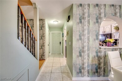 Hall featuring stairway and light tile patterned f