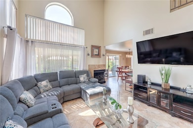 Living area with a high ceiling and a fireplace