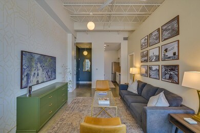 Living area with concrete floors, a high ceiling,