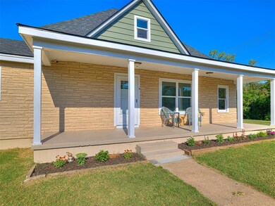 View of front facade with a porch and a front lawn