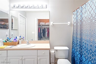 Full bath with vanity, toilet, a walk in closet, a