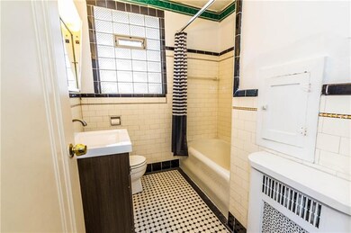 Classic black and white tile bath with newer vanit