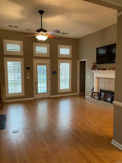 Great Room with high ceiling, ceiling fan and fire