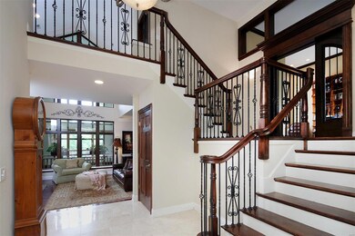 Striking front entry foyer!  At first level up (6 steps up on right) is executive study with 13 ft ceiling, built in bookcases and door to outside. Straight ahead is dramatic family room with atrium view.