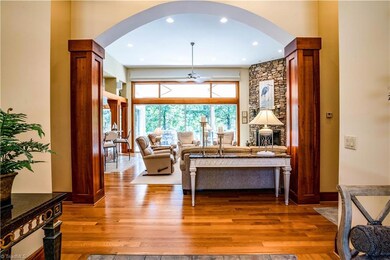 View from foyer of great room.  Hallway to right leads to large beautiful owner's suite, powder room, and laundry.  Hallway to left leads to bedrooms 2, 3, 4, bonus room and garage. 