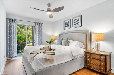 Bedroom with access to exterior, wood finished floors, and a ceiling fan