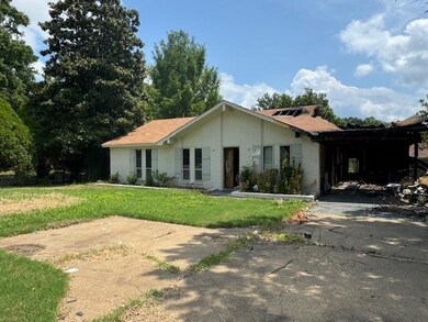 View of front of house featuring a carport and a f