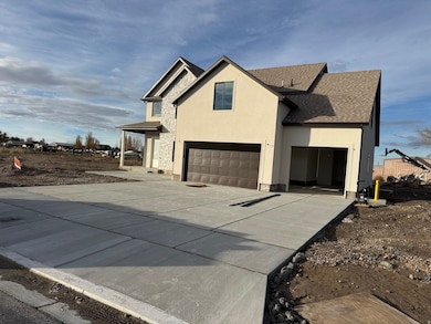 View of home's exterior featuring roof with shingles, stucco siding, concrete driveway, stone siding, and an attached garage