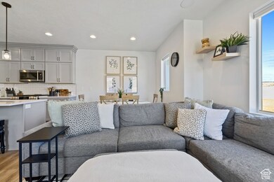 Living room with recessed lighting, light wood-type flooring, and plenty of natural light