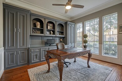  Study/ office features wall of gray built-in bookcases and cabinets.