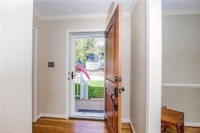 Enter into welcoming foyer with hardwood floors.