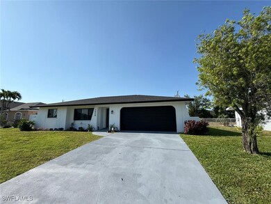 Ranch-style home with a front lawn, driveway, fenc