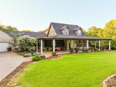 View of front of home featuring a porch, a front lawn, driveway, and roof with shingles