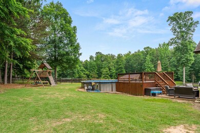 View of yard with a playground, outdoor lounge area, an outdoor pool, and a patio