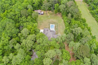 Aerial view featuring a wooded view