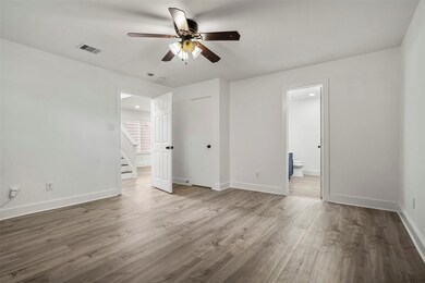 Spacious bedroom with modern floors and ceiling fa