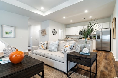 Living room with dark wood finished floors, recess