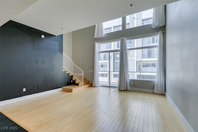Unfurnished living room featuring stairway, basebo