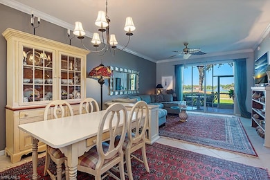 Dining room with crown molding, ceiling fan, light tile patterned floors, and a chandelier