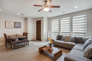 Living room with recessed lighting, baseboards, v