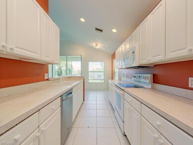 Kitchen with white cabinets, vaulted ceiling, whit