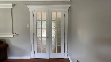 Entryway with french doors and dark wood-style floors