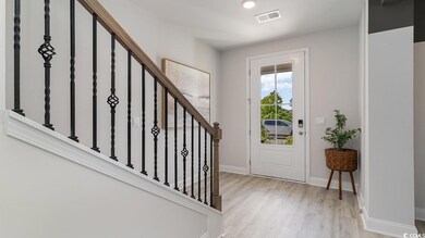 Foyer entrance with light hardwood / wood-style fl