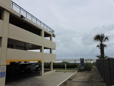 View of building exterior with parking