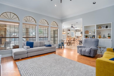 Living room featuring a high ceiling, ornamental m