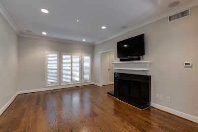 Living room has hardwood floors, new paint, crown