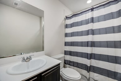 Bathroom featuring vanity and a shower with shower curtain