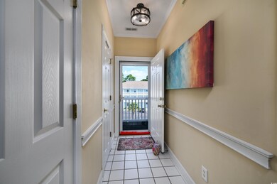 Doorway featuring light tile patterned flooring