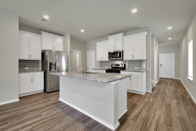 All new stainless steel appliances in the amazing kitchen that has lots of cabinets and a walk in pantry.