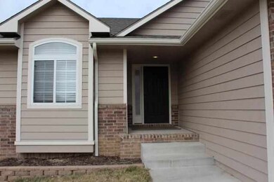 BRICK TRIMMED AND COVERED FRONT PORCH