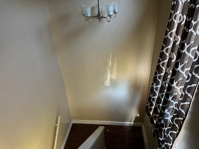 Stairs featuring hardwood / wood-style flooring an