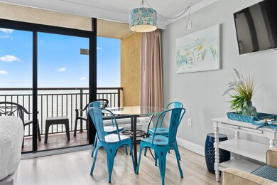 Dining space with a wall of windows, wood finished floors, and crown molding