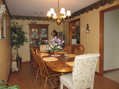 Large dining room has laminate wood flooring and b