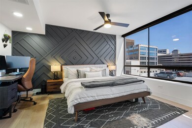 Bedroom with wood finished floors, a view of city