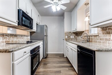 Kitchen with decorative light fixtures, sink, whit