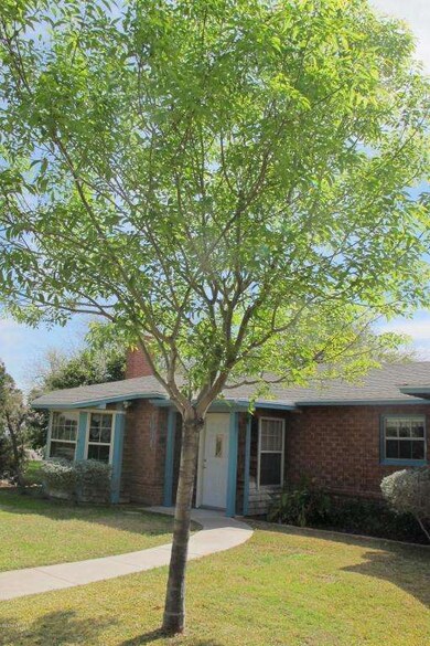 Front of home with mature trees