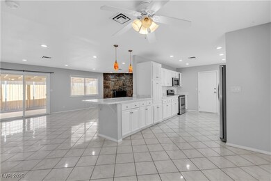 Kitchen featuring a ceiling fan, appliances with s