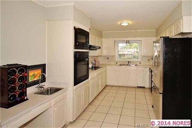 The kitchen is unique in size as it spans the leng