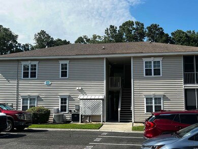 View of property featuring uncovered parking