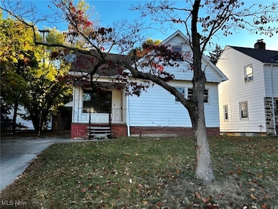 View of front facade with a front lawn and covered porch