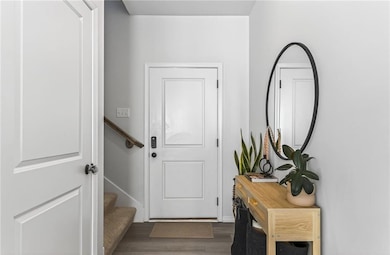 Entryway with wood finished floors and stairway