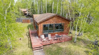 View of yard featuring a deck and an outbuilding